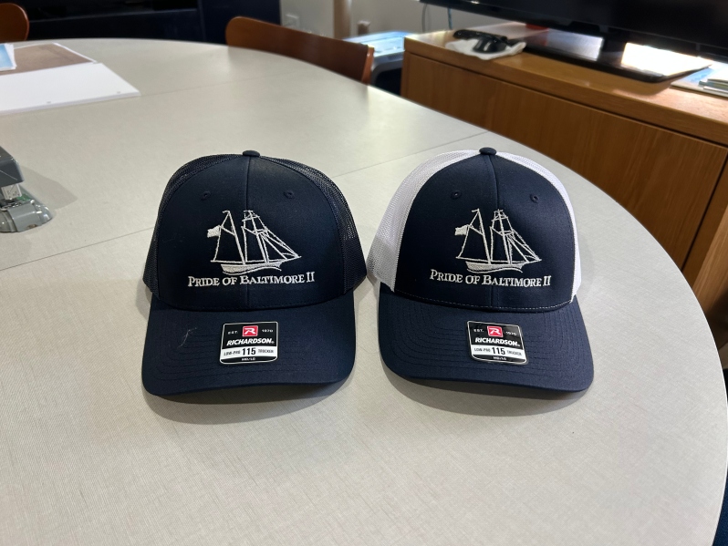 Product Description: Show your Pride in classic style. This Richardson 115 mesh back trucker hat features a mid-profile fit, pre-curved visor, and adjustable snapback for all-day comfort on or off the water. Available in all navy or navy/white.</br> Trucker Cap